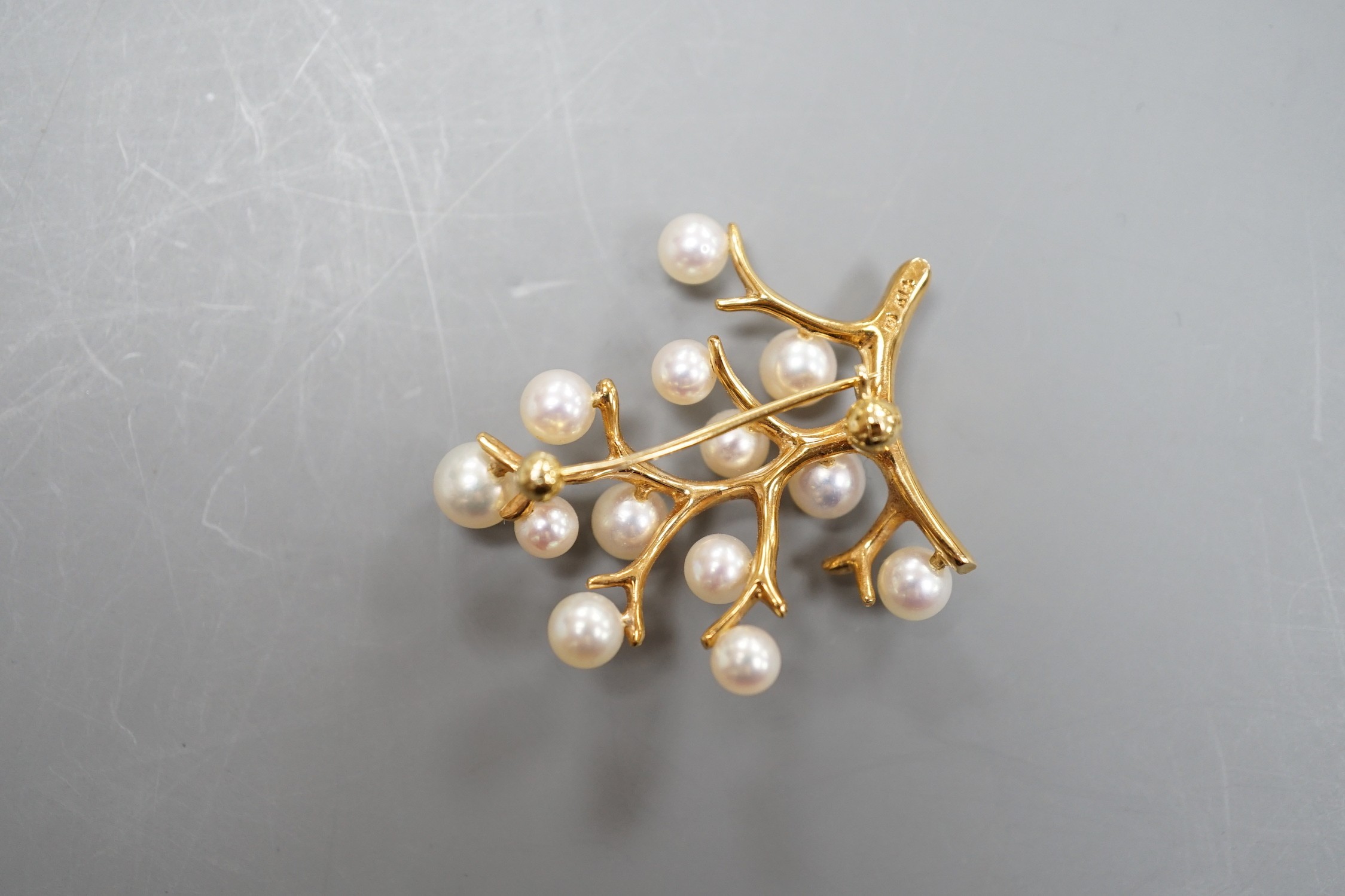 A Mikimoto 14k yellow metal and cultured pearl set cluster spray brooch, 34mm, gross weight 5.9 grams.